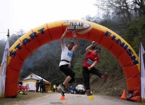 Two runner jumping at the finish line of full 42.195 km Coronation Marathon 2024